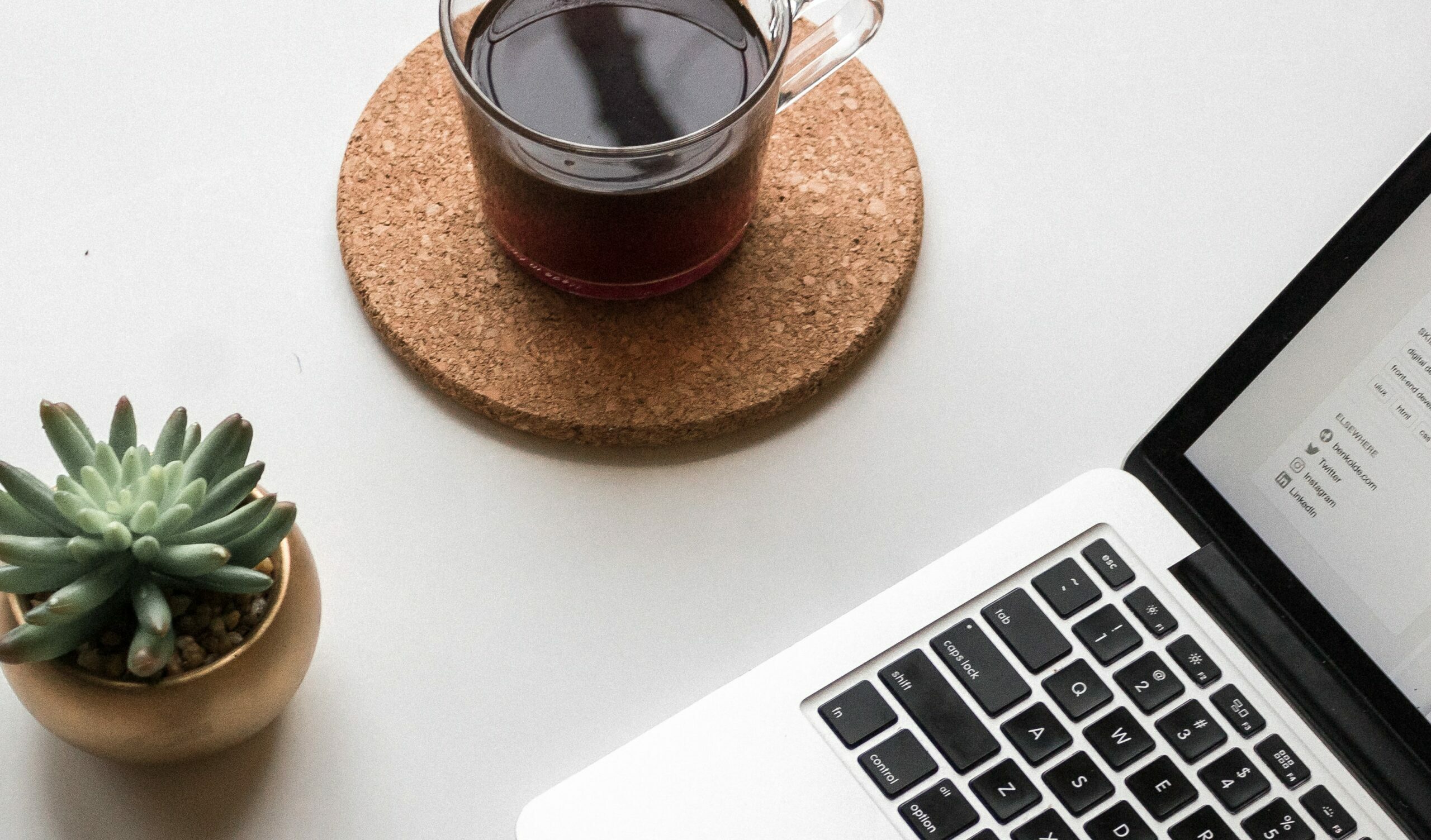 Laptop and cup of coffee on a table