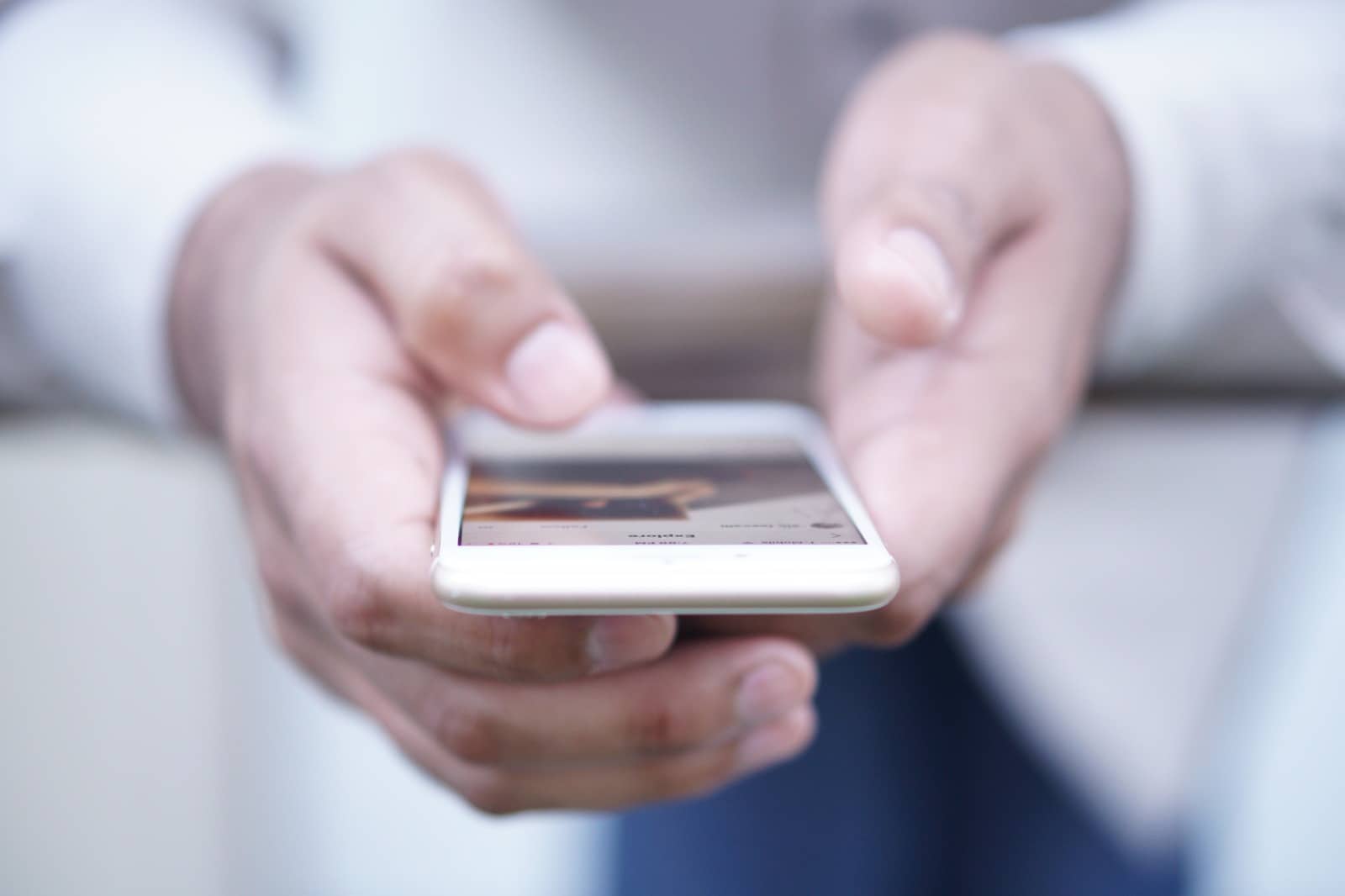 How to Repost on Instagram. Woman holding a phone.