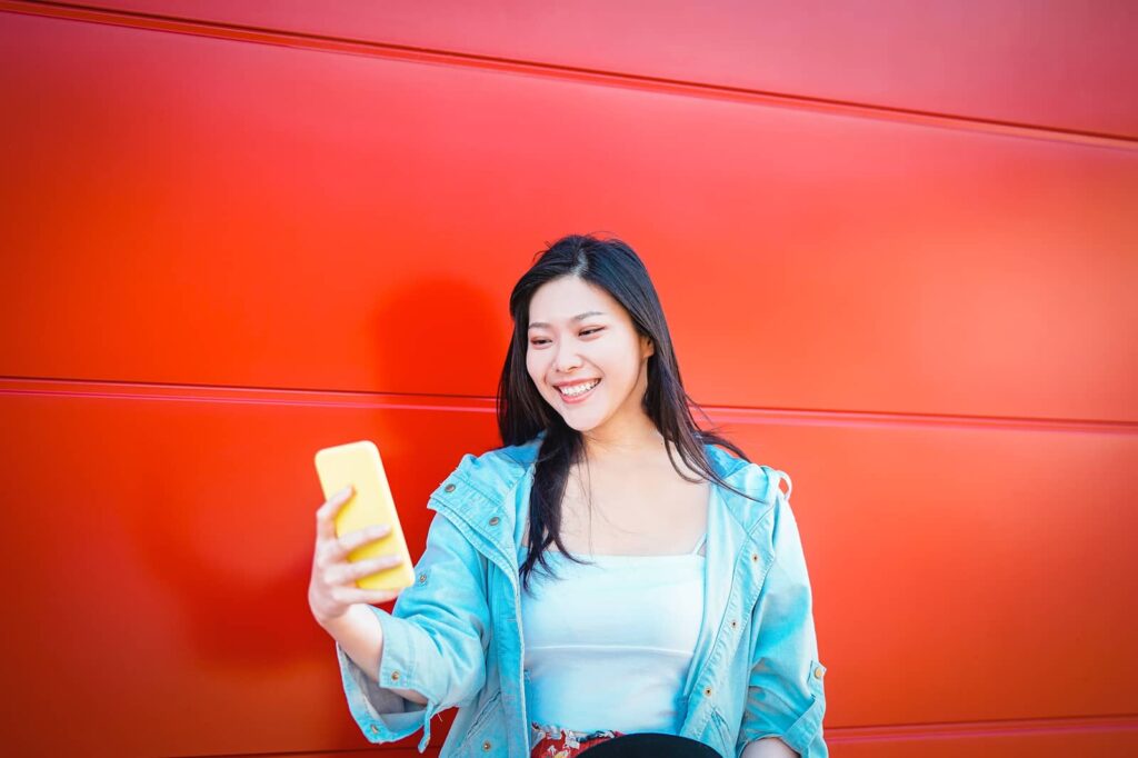 How to unblock someone on Instagram. Asian woman taking a selfie.