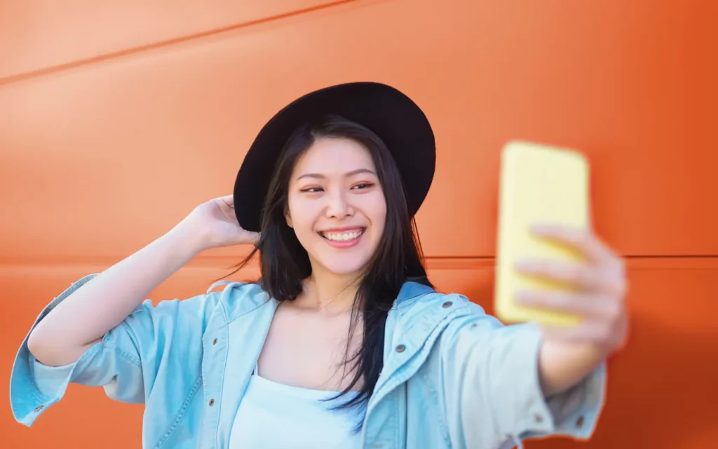 A girl is taking a photo with her phone