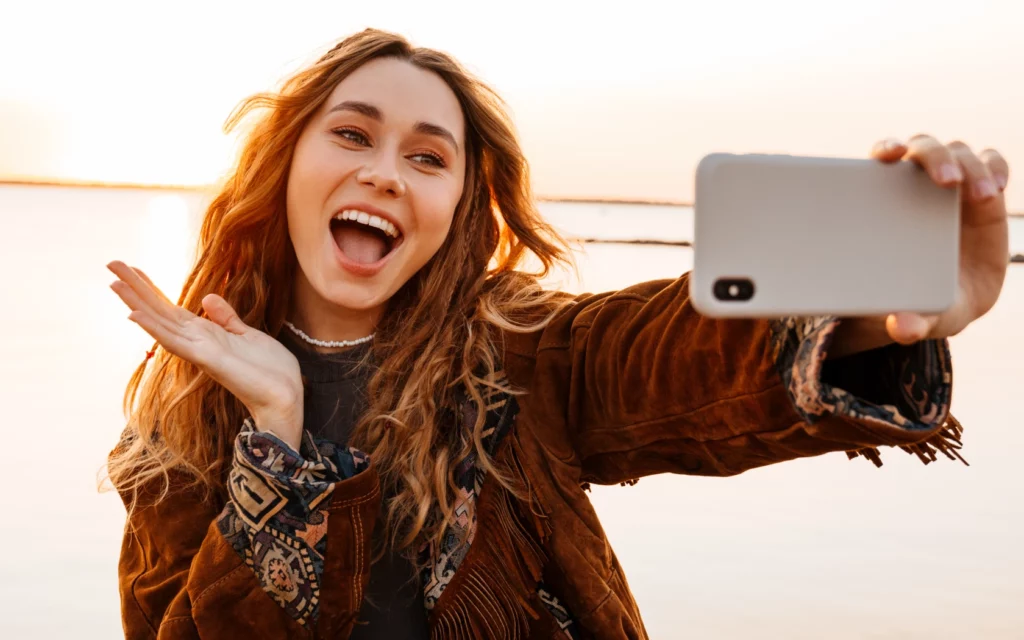 Woman taking a selfie at the beach