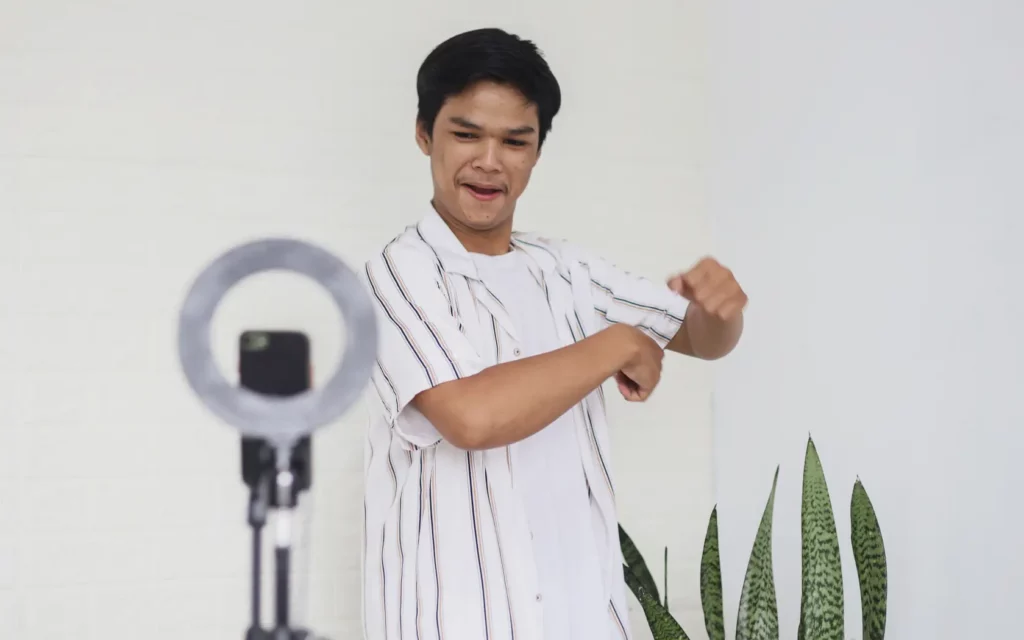 Young Asian man dancing on the camera for his social media profiles