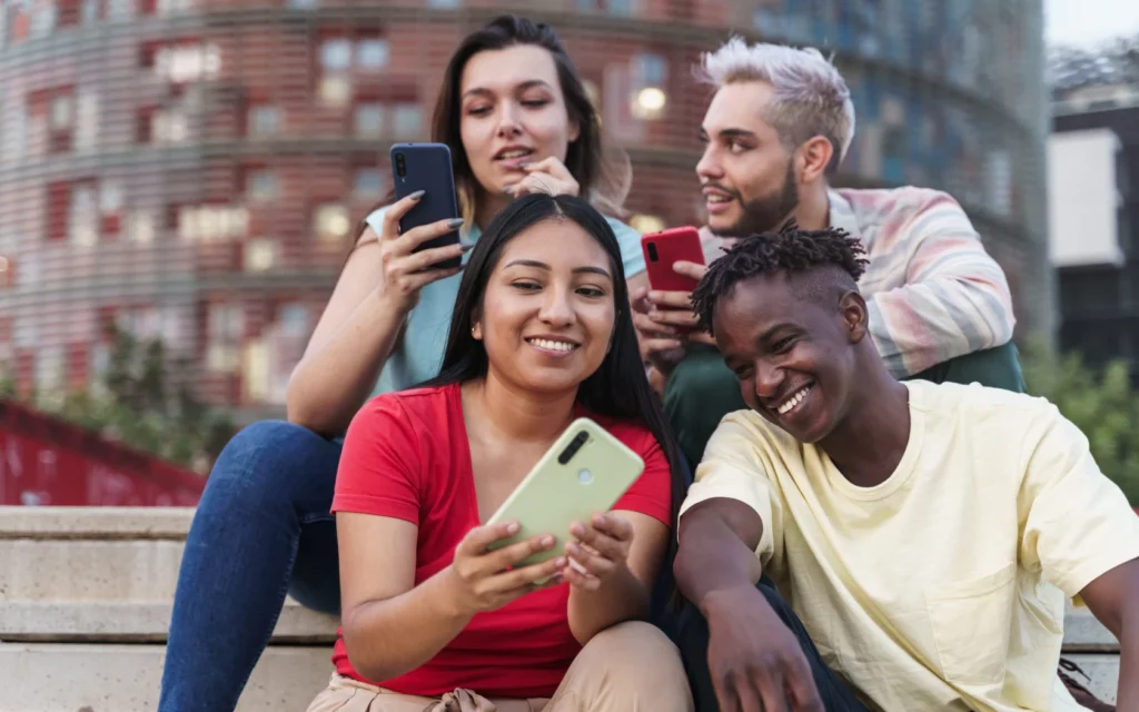 Group of friends taking photos for Instagram posts