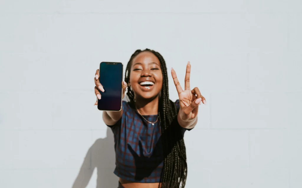 Smiling young woman taking a selfie