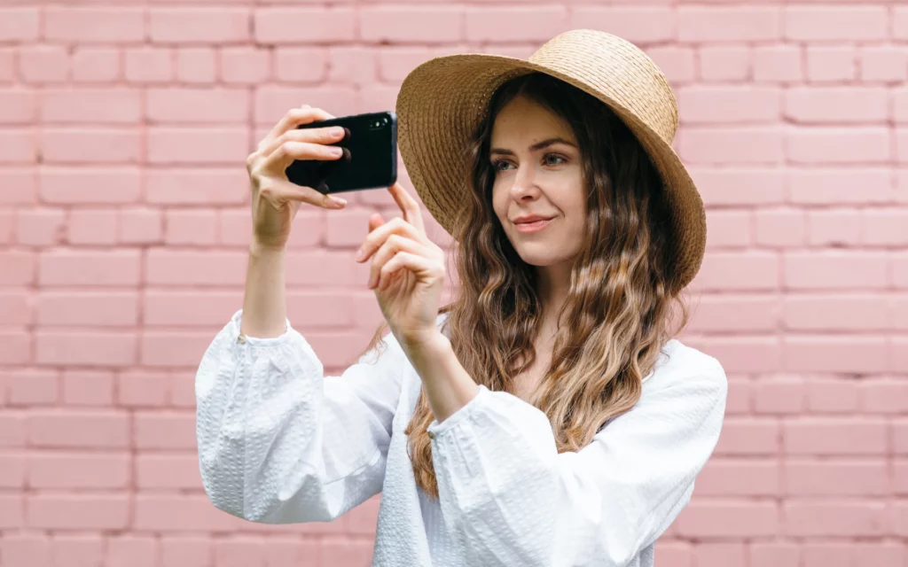 Woman taking a selfie to post on social media