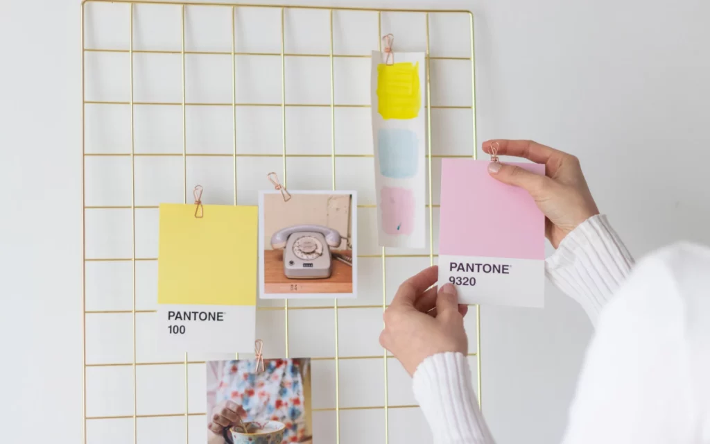 Woman shows putting up pictures on the wall.