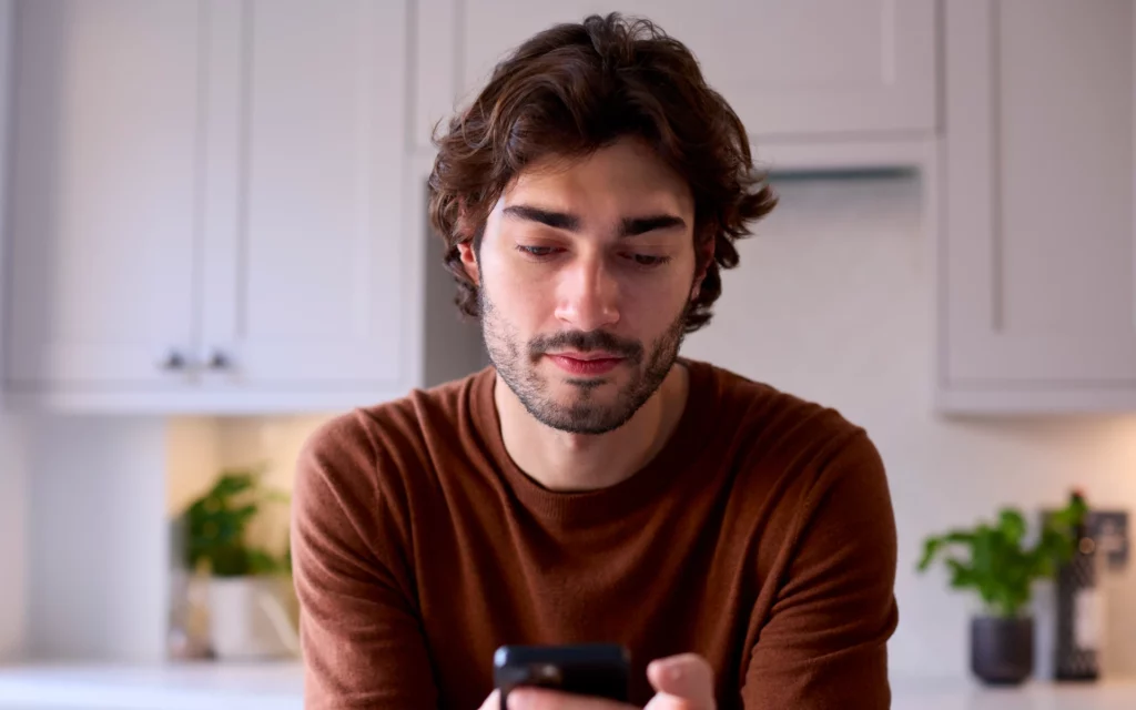 A man searching for Instagram on his mobile browser.