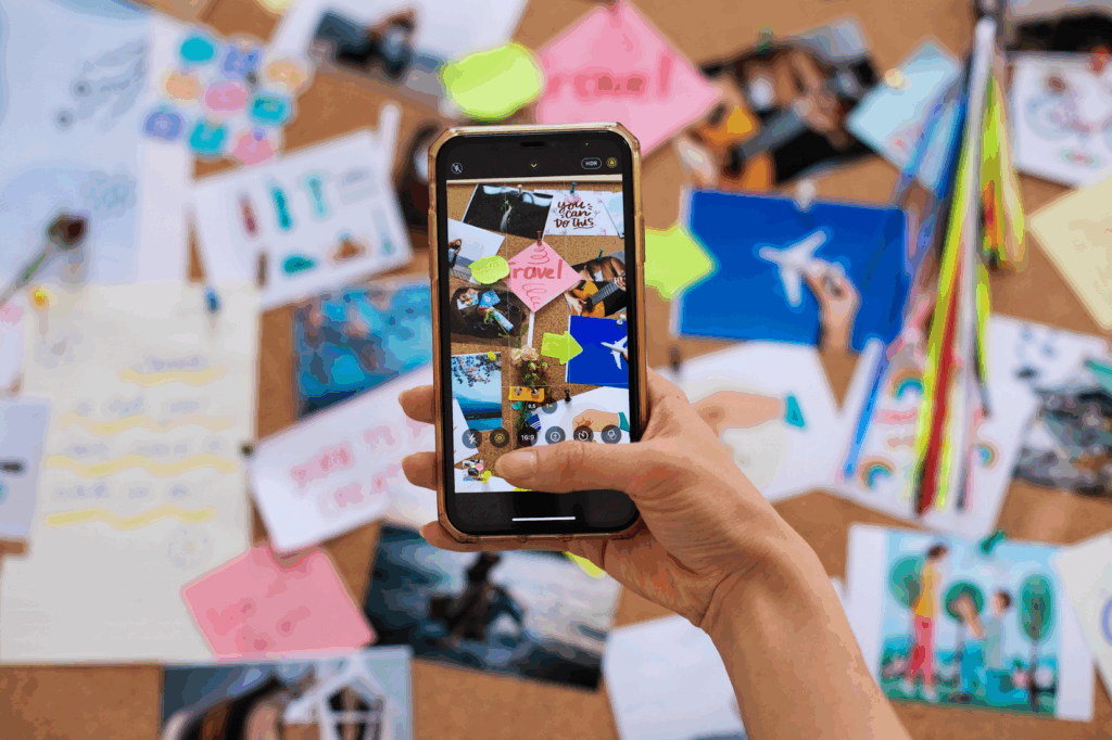 Creator using a smartphone to photograph visual content for social media branding and custom text posts