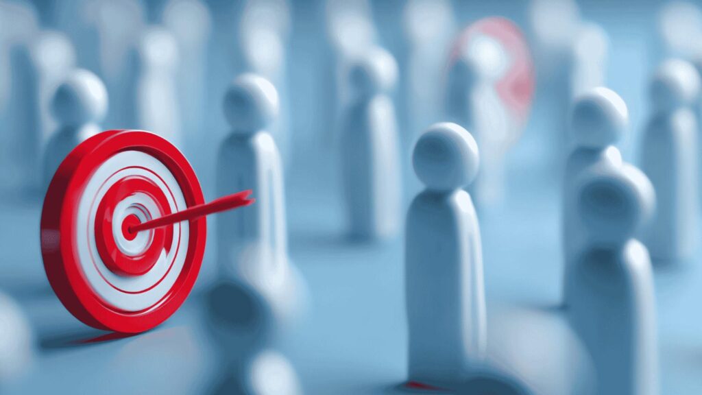 Red bullseye target with an arrow in the center in front of blurred white human figures