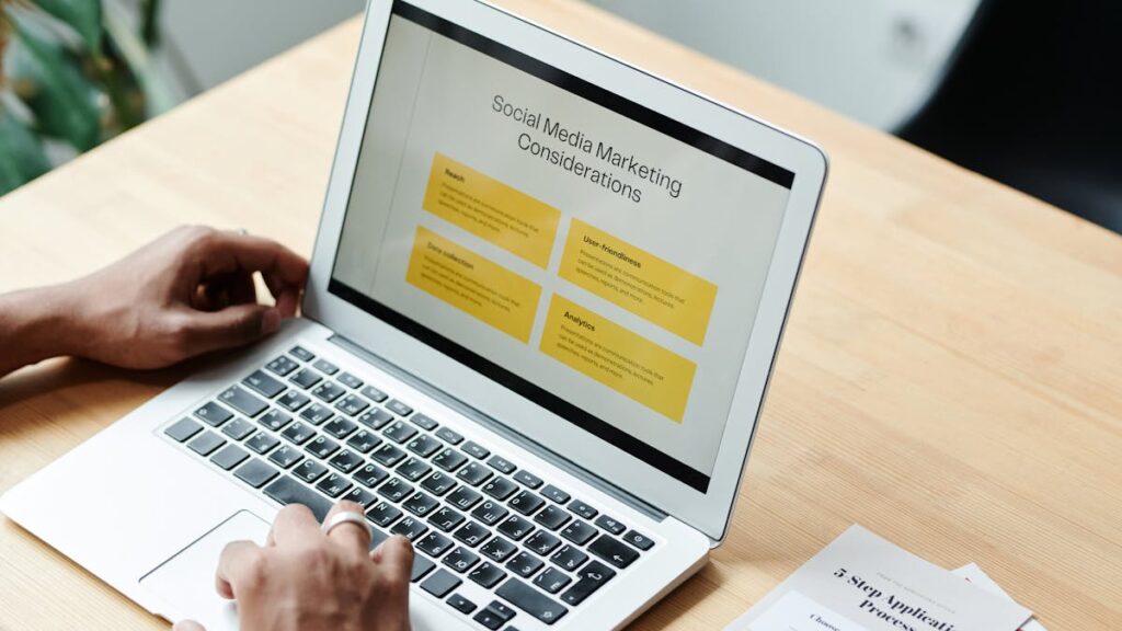 A person using a laptop to review social media marketing strategies at home.