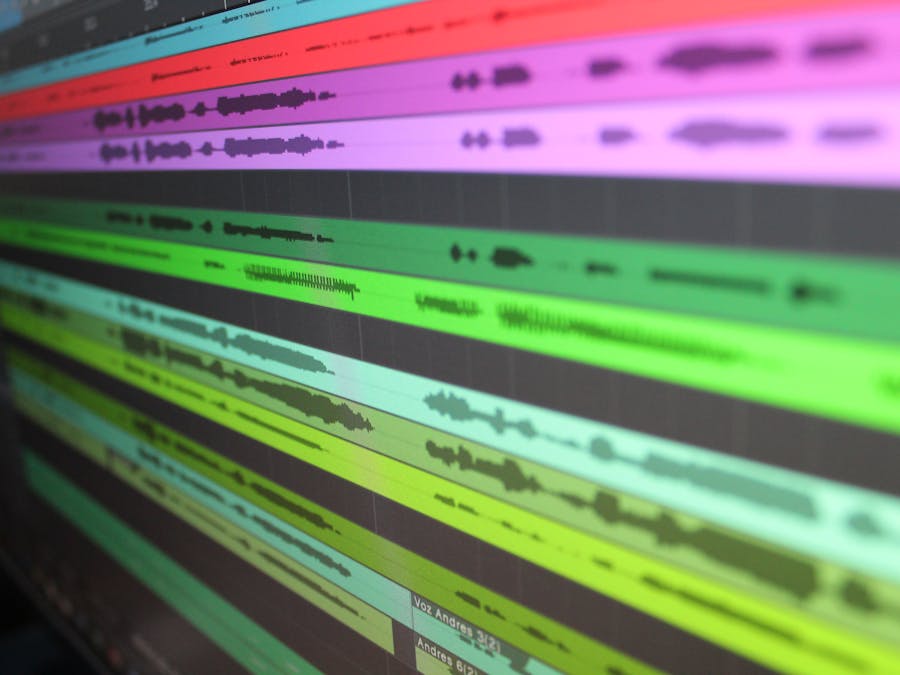 Close-up of audio waveforms on screen, showcasing music production software in use.