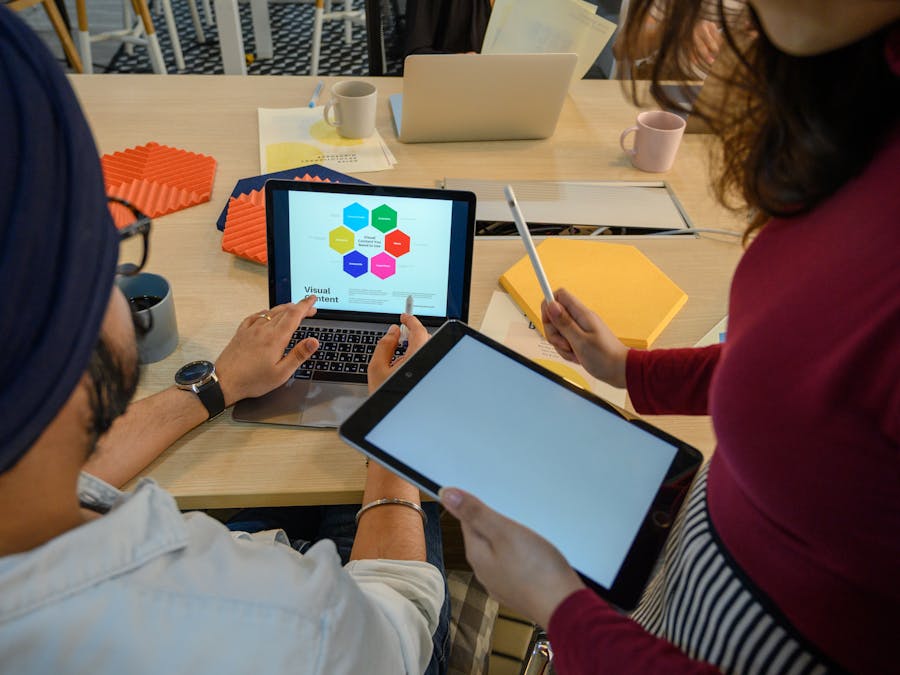 Creative meeting with digital devices in a modern office, showcasing teamwork and collaboration.