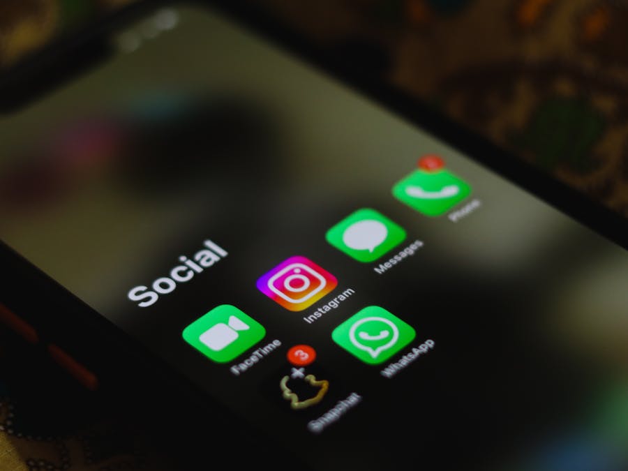 A close-up shot of smartphone displaying social media apps icons on screen.