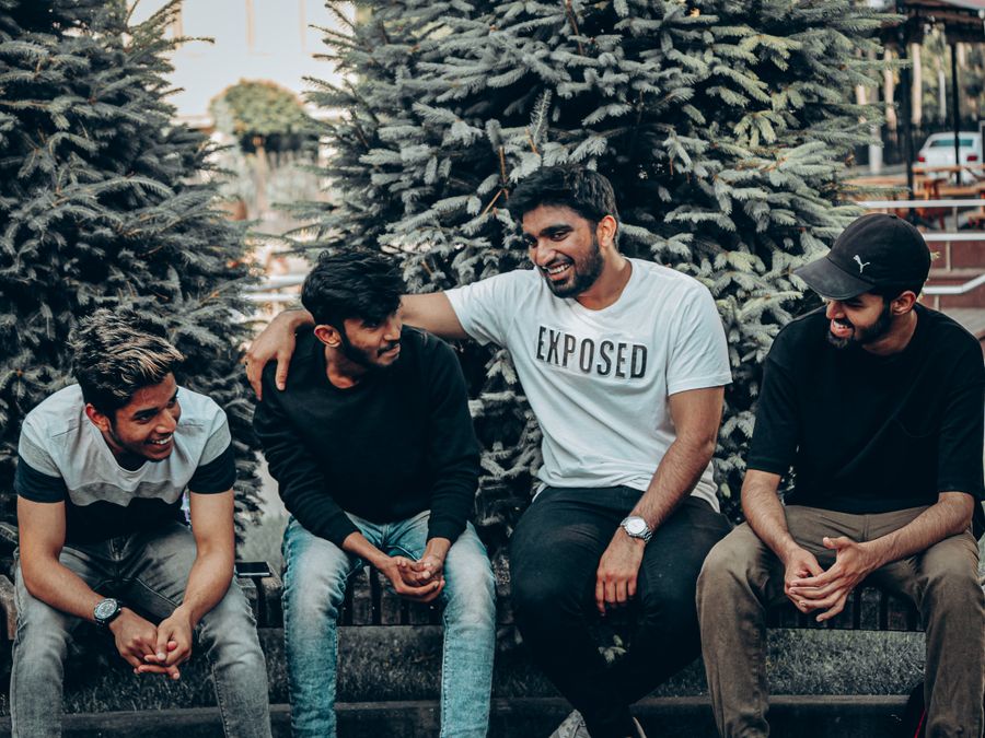 A group of friends enjoying a casual outdoor gathering in Moldova, smiling and conversing.