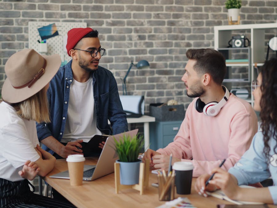 Young creative team discussing project ideas in a modern office setting.