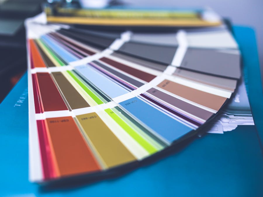 A collection of colorful paint swatches spread out showcasing a variety of hues.