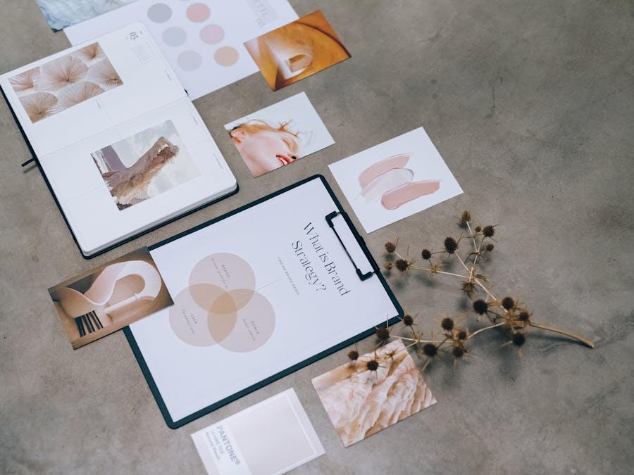 A modern flat lay of branding strategy documents and design elements on a desk.