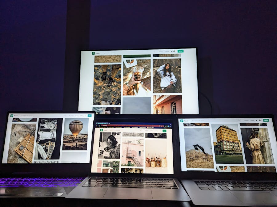 A modern digital setup with multiple screens showcasing diverse photographs, ideal for creatives.