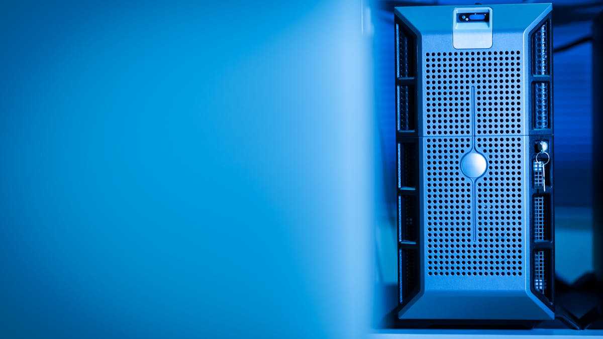 Close-up of a modern server unit in a blue-lit data center environment.