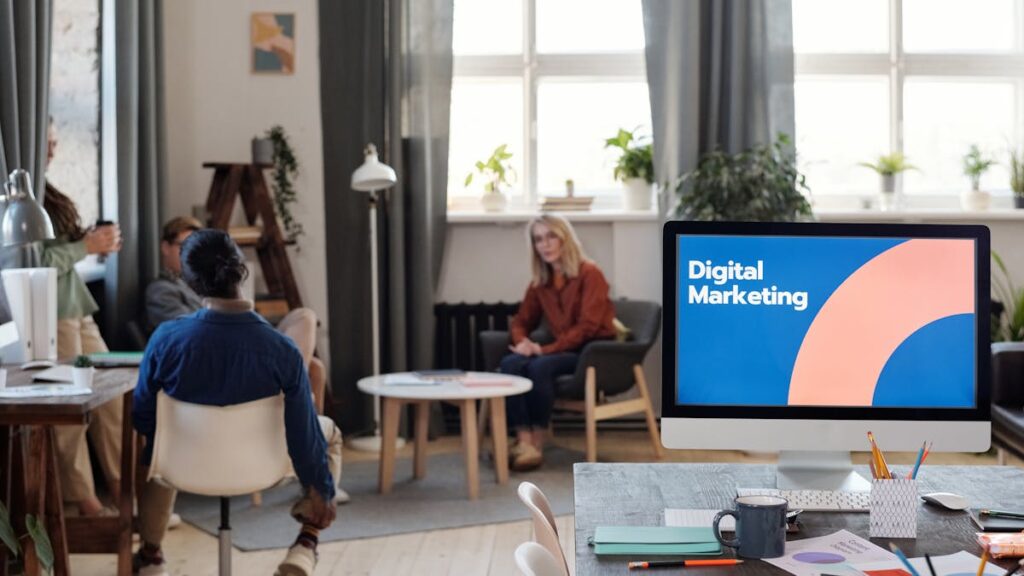 A diverse team engages in a digital marketing meeting in a stylish office setting.