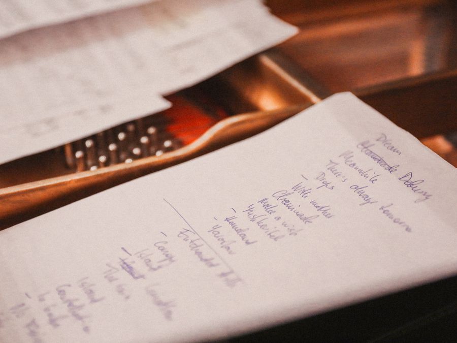 Close-up of a handwritten checklist on paper in warm light. Ideal for planning and organization themes.