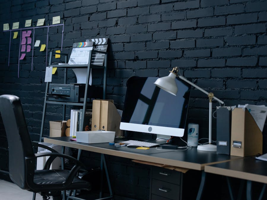 Stylish home office setup with desktop computer and organized workspace.