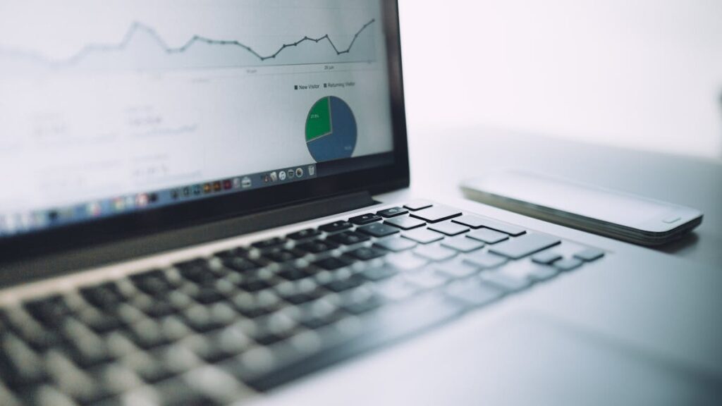 A laptop showing an analytics dashboard with charts and graphs, symbolizing modern data analysis tools.