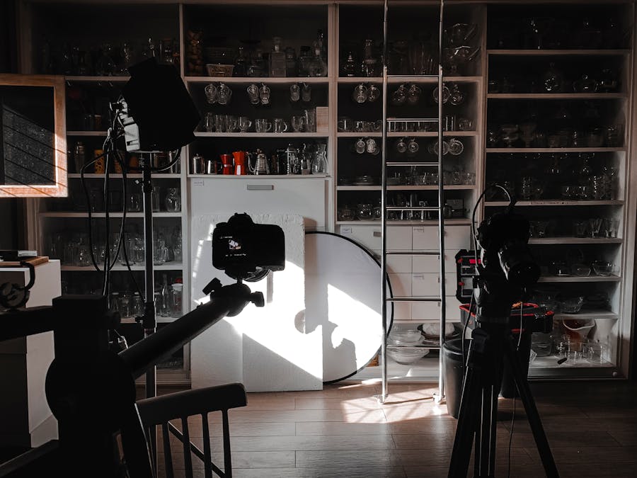 Interior view of a photography studio with cameras, lights, and equipment setup for a shoot.