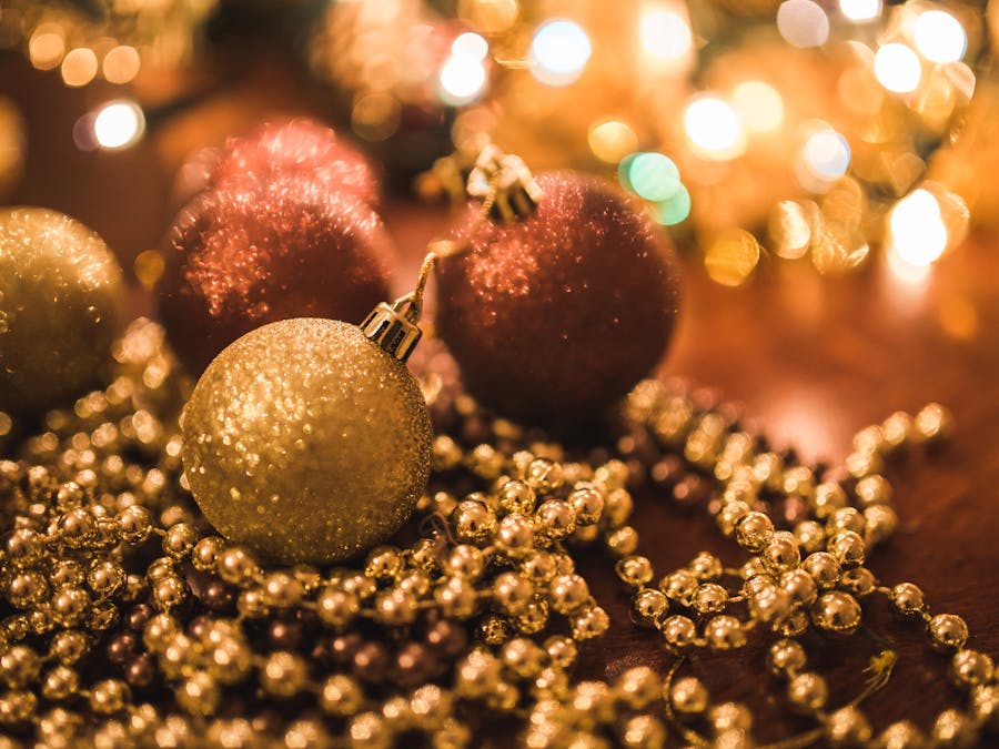 Warm holiday decorations with golden and red ornaments, perfect for festive celebrations.