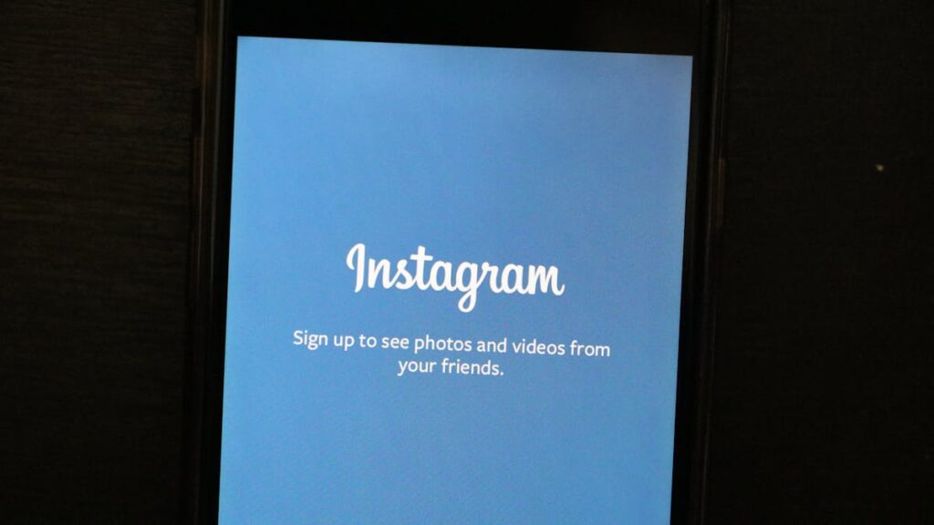Close-up of a smartphone displaying the Instagram app welcome screen, inviting users to sign up.