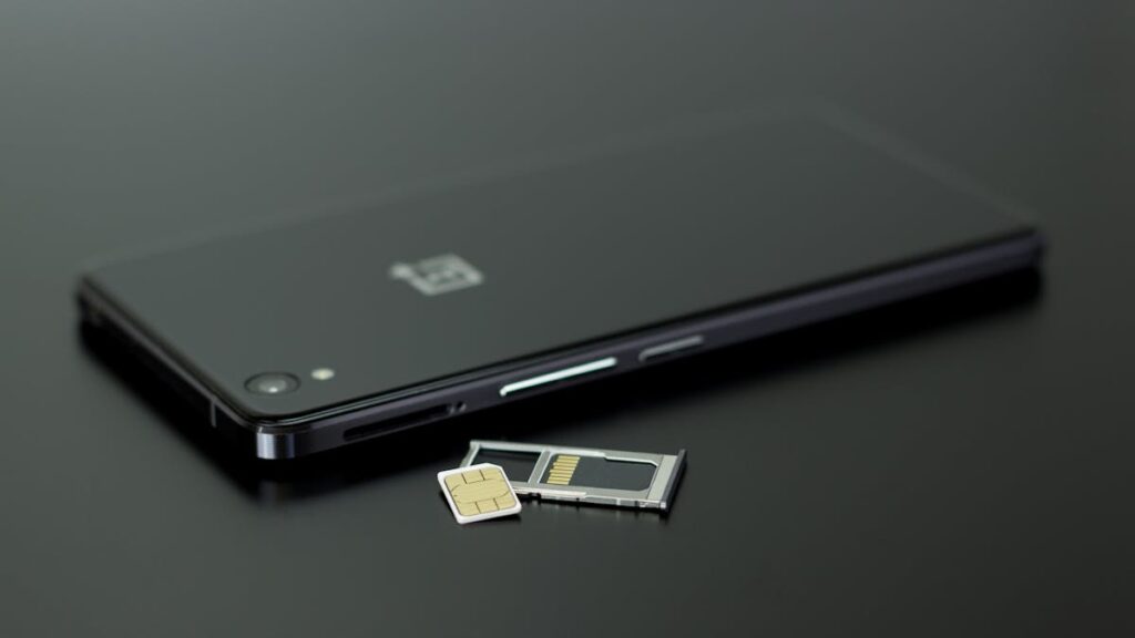 Close-up of a smartphone with a SIM card and memory card, showcasing modern technology.