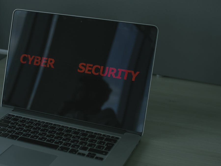 Close-up of a laptop displaying cybersecurity text, emphasizing digital security themes.