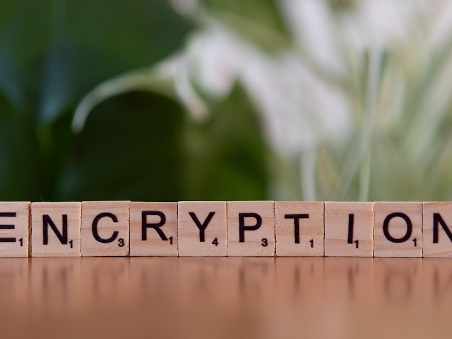 Close-up of wooden blocks spelling 'encryption', symbolizing data security and digital protection.