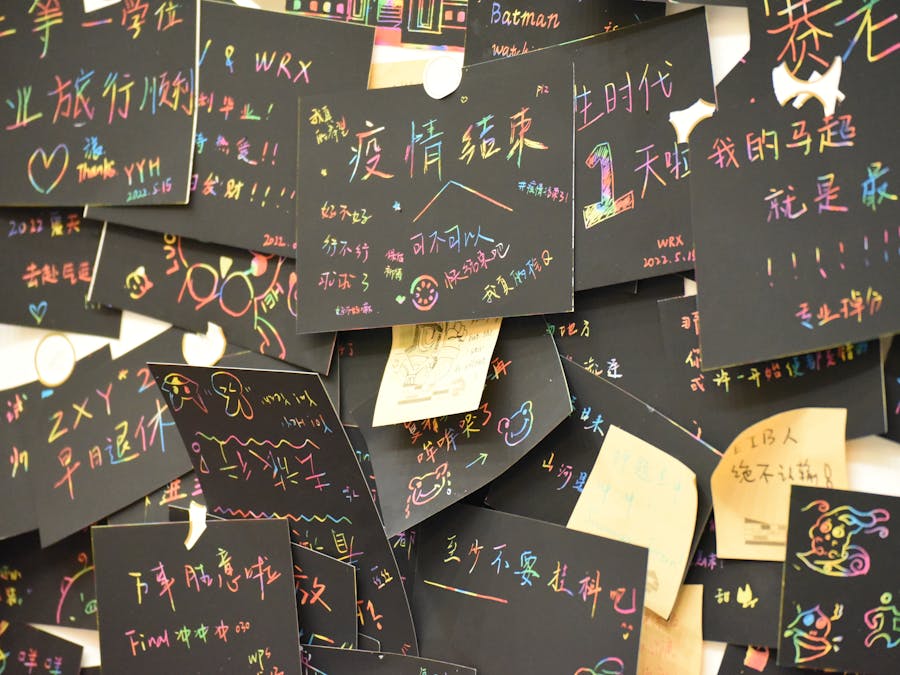 Close-up of vibrant handwritten messages on black postcards for creative inspiration.
