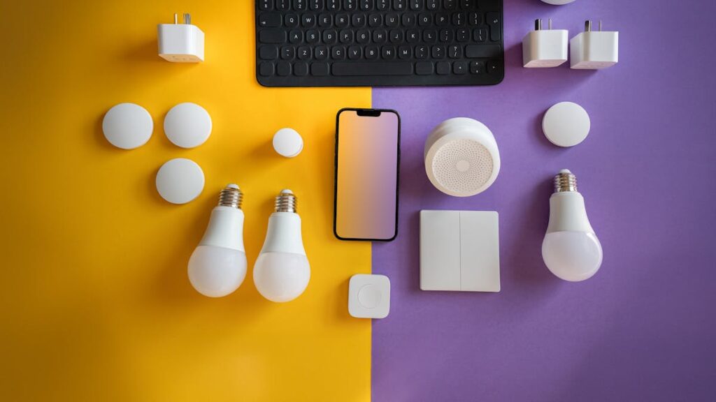 Flat lay of electronics, smart home gadgets on a colorful background for tech concepts.