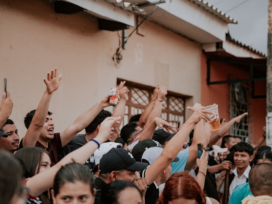 A lively crowd gathers in an urban street celebration, capturing the essence of community joy.