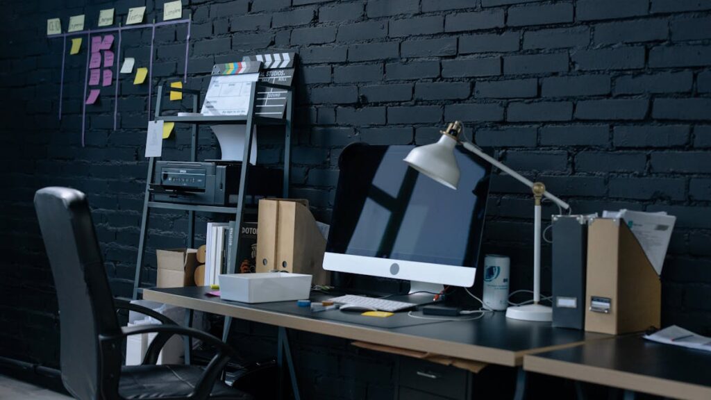 Stylish home office setup with desktop computer and organized workspace.