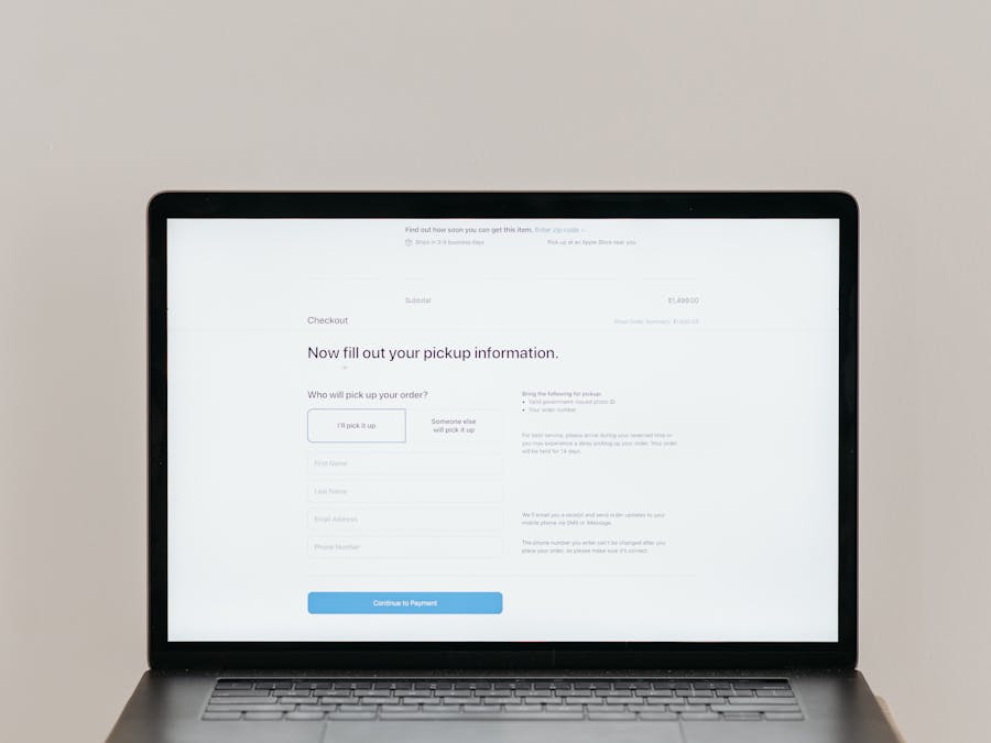 A laptop displaying an online checkout form, highlighting technology and e-commerce.