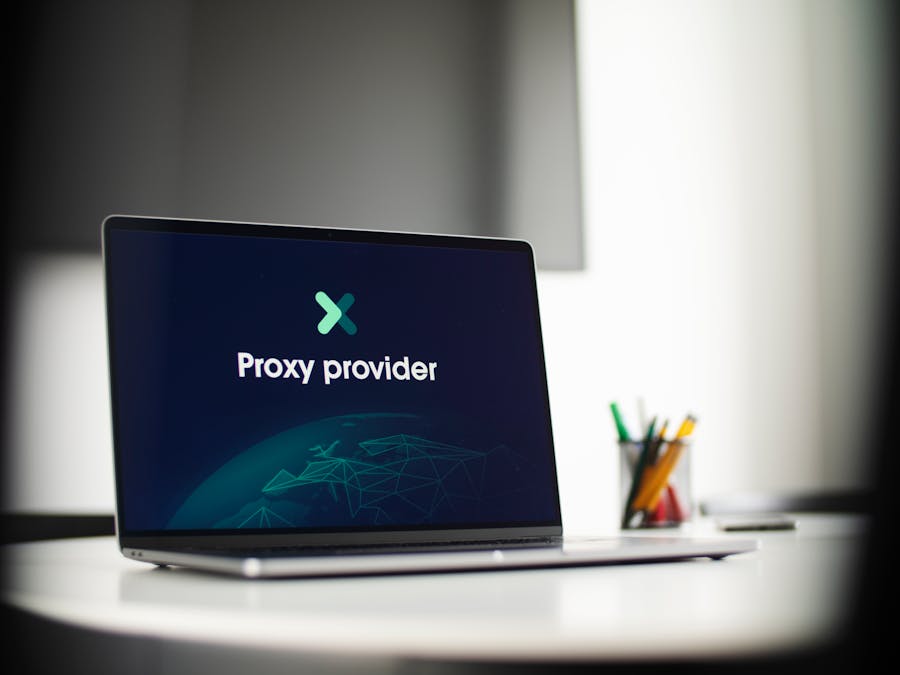 Laptop screen showing 'Proxy provider' in a tech office setting, focus on cybersecurity.