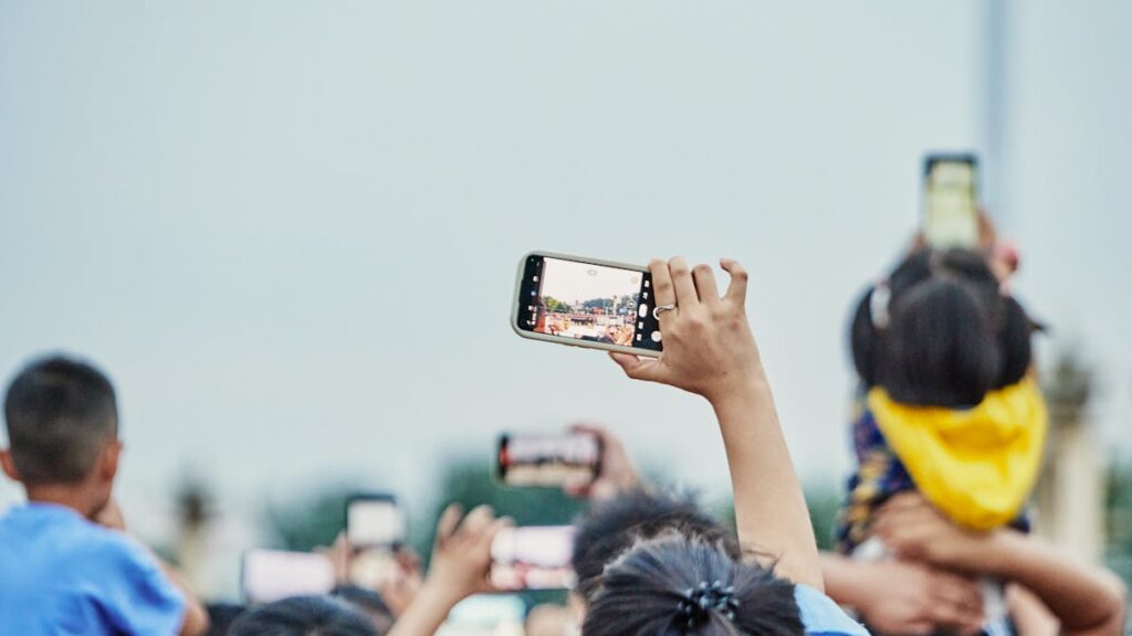 A lively crowd capturing an event on smartphones, showcasing modern digital engagement.