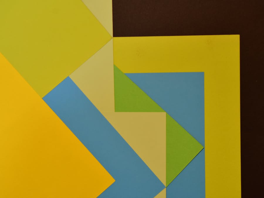 Vibrant abstract composition of colorful geometric paper shapes creating a modern art piece.