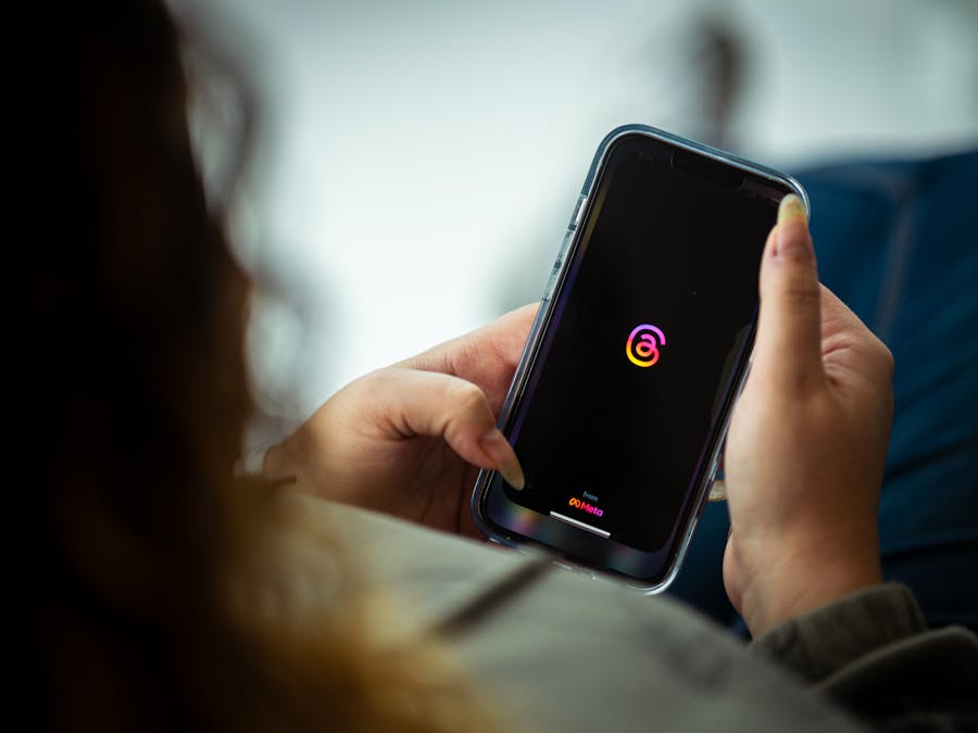 Close-up of a person holding a smartphone with a social media app open