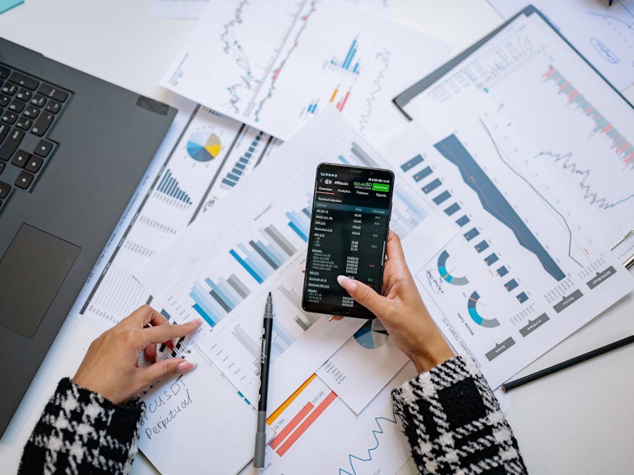 A top view on charts and smartphone in an office, showcasing data analytics.