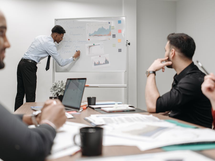 Colleagues in a business meeting discussing data and strategies at the office.