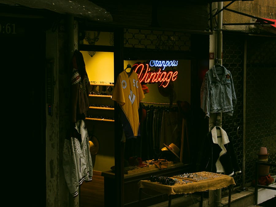 Charming vintage clothing store in Istanbul with neon signage and stylish window display.
