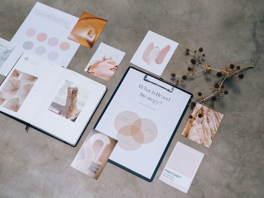 Flat lay of branding strategy materials with moodboard and color palette for creative design.