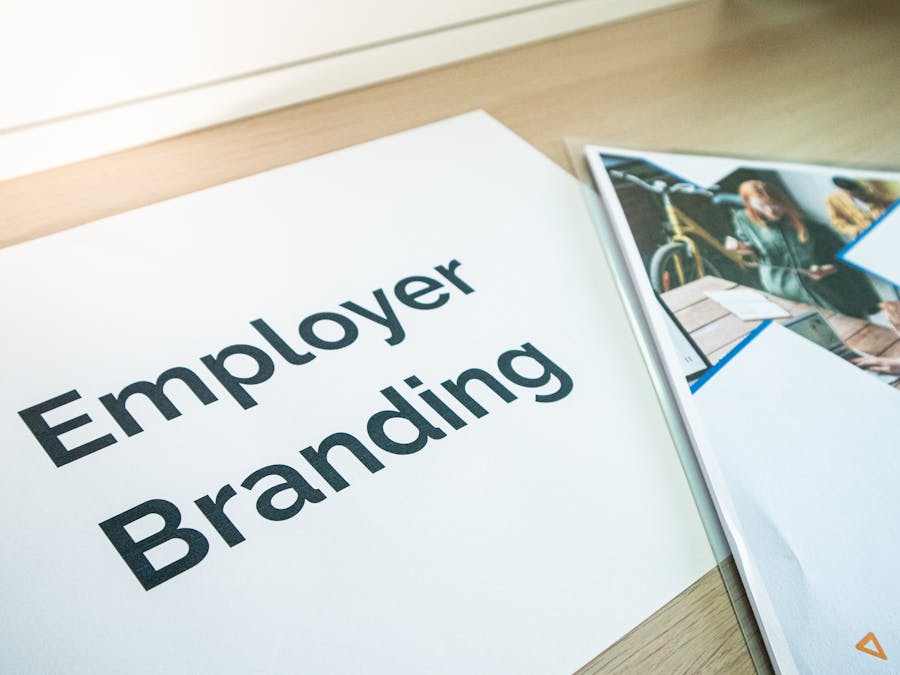 Focus on employer branding with documents on a wooden desk, ideal for business concepts.