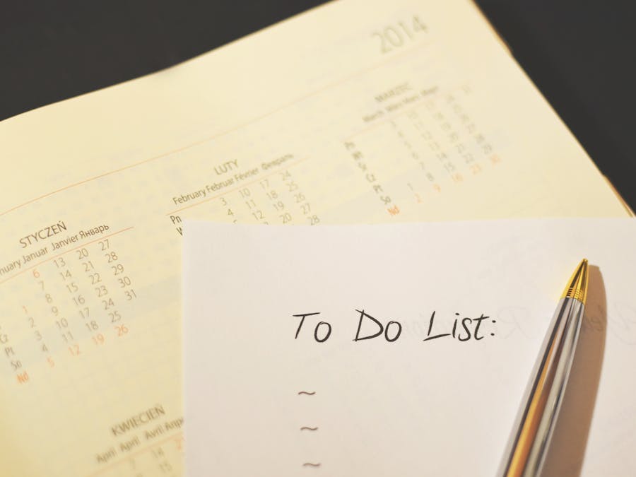 Close-up of a calendar and to-do list on a desk, emphasizing planning and organization.