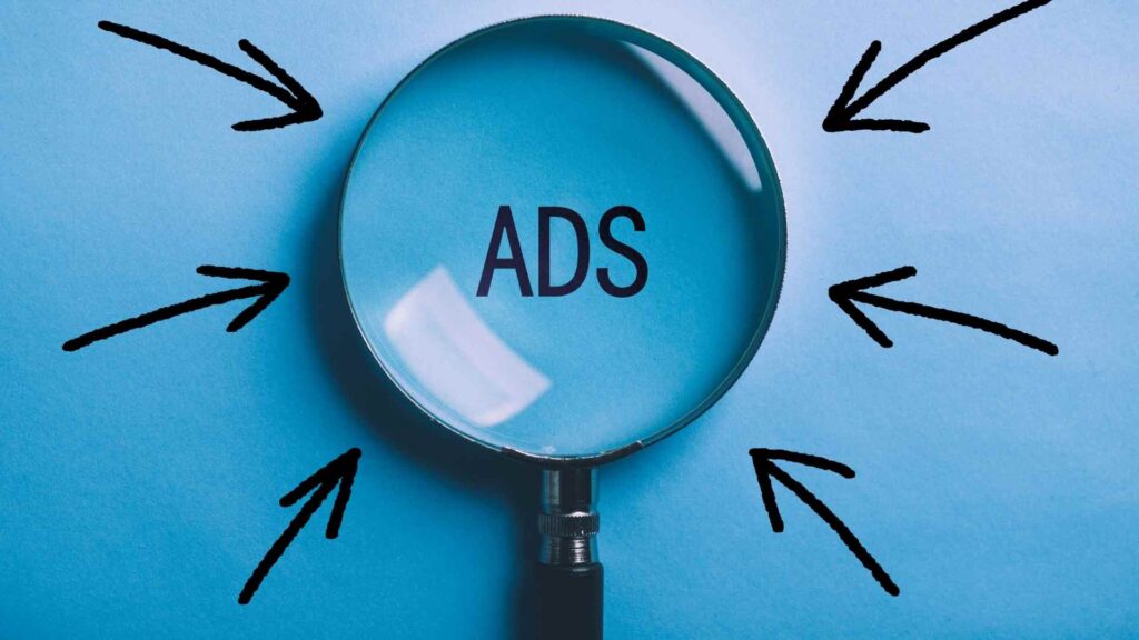 Magnifying glass highlighting online ads with arrows pointing toward the campaign