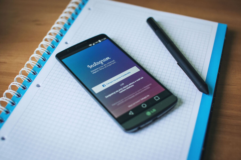 Smartphone with Instagram open on a student notebook